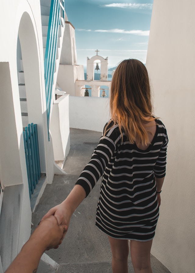 Couple walking through quiet traditional village alleys in Pyrgos, Santorini for a romantic walk