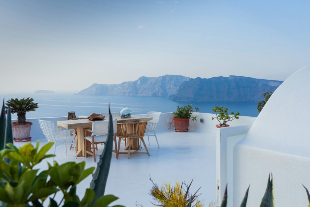 A table of local Santorinian dishes and wine on a terrace
